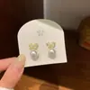 Pendientes de lujo de alta gama con lazo de circón y perla en dorado y plateado, exquisitos y elegantes para ir al trabajo, pendientes de temperamento suave al por mayor