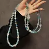 Cadena de hueso de serpiente plateada nueva de alta gama con colgante de espejo de gota de agua para teléfonos, bolsos y bolsos cruzados al por mayor