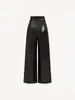 Pantalones retro de cuero PU de color negro transfronterizos para mujer, estilo chica popular de la calle, pantalones de pierna ancha de color liso desgastados para mujer, envío directo de una pieza