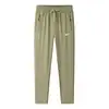 Calça Esportiva Casual de Primavera e Outono para Homens, Tecido de Nylon Elástico, Confortável e Respirável, Calça Longa Lisa Versátil para o Dia a Dia