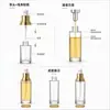 Botella de vidrio transparente para loción con detalles dorados, apta para serigrafía, 50/60 ml, para productos de cuidado de la piel, sérums y aceites esenciales, con dispensador de bomba