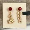 ¡Hazte rico pronto! Pendientes de Borla con Moneda de Caballo Rojo, Lujo Ligero, Nobles y de Gama Alta, Estilo Nicho, Pendientes de Año Nuevo para Mujer