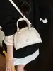 Bolsa de boliche de nicho para mujer, nuevo bolso de mano pequeño de moda 2026, diseño casual versátil, bolso de hombro y cruzado