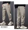 Estoque de fábrica mais calças de veludo masculino outono soltas calças casuais masculinas calças de moletom calças esportivas calças afuniladas versáteis preto