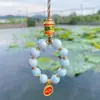 Estilo étnico aleación porcelana vidrio cadena para teléfono móvil llave thangka cinco vías dios de la riqueza colgante galvanizado joyería de palacio