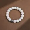 Material de intemperie de raíz de Bodhi de Jade Blanco de Hainan hecho a mano pulido en seco alto lanzamiento espaciador de cuerda trenzada colgante de loto tallado pulsera pulsera