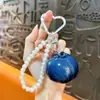 Pingente de chaveiro de corrente de pérolas de frutas simuladas, doce e versátil, design fresco e simples, moderno e único