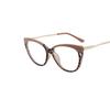 Nuevas gafas de moda transfronterizas europeas y americanas TR90 con diseño de ojo de gato y protección contra la luz azul, con personalidad femenina, montura de gafas con patas de resorte de metal