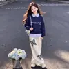 Conjunto casual y elegante de chica con personalidad, top de retazos a rayas con cuello de polo, estilo dos piezas falsas, pantalones casuales retro de mariposa, moderno