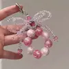 Estilo Doce Lanyard Rosa com Contas em Formato de Laço para Celular para Mulheres Pingente de Strass Super Brilhante Estilo Fashion Chaveiro de Bolsa Estilo Luxo Leve