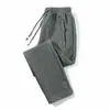 Pantalones gruesos con forro polar para otoño e invierno, nuevos, holgados, combinables, casuales, de moda, para hombre, pantalones deportivos de talla grande con cremallera y bolsillo.