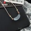 Collar Natural Color Hielo Ojo de Gato Sonrisa Tubo Curvo Clavícula para Mujer Cuerda Tejida a Mano Estilo de Diseño de Alta Gama Collar al por Mayor