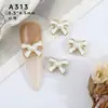 Joyería de red para arte de uñas, estilo pequeño y fragante de moda, perla de gota de aceite, lazo, accesorios de joyería de aleación para uñas en blanco y negro, venta al por mayor