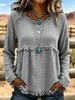 Blusa longa de manga comprida, estilo boho europeu e americano, com franjas, textura e amassada, gola redonda, corte solto e ombros caídos.