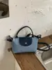 2026 Nuevo Estilo Fresco Lunares Personalidad Elegante Patchwork Bolso de Hombro Relajado Bolso Cubo Moderno Bolso de Hombro para Viajes