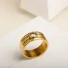 Explosões de rede INS titânio aço três camadas anel redondo zircônio banhado a ouro 18K masculino e feminino Anel Coringa atacado