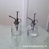 Suministro de fábrica regadera regadera botella de vidrio transparente regadera para plantas estilo pastoral utensilios de riego para jardín