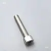Accesorios para telar de chorro Tsudakoma Red Flag, que incluyen un pequeño bloque cuadrado de metal con un resorte en cada extremo, tornillos de 5M y un marco integral South Sea