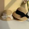 Nuevo sombrero de paja decorado con lazo para mujer, sombrero de sol versátil de ala ancha para salidas de vacaciones de verano en la playa