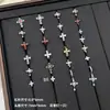 Nuevos y modernos aretes de cruz con diamantes completos Jiuhan para mujer, ear cuffs de acero de titanio de nicho, populares tachuelas de hueso de la oreja de alta gama