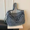 Bolso de hombro casual y de moda con remaches estilo coreano 2026, bolso de mezclilla diario para mujer
