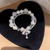 Pulsera de perlas con lazo de doble capa estilo vintage francés, diseño único y versátil, joyería de lujo ligero y de alta gama