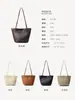 Bolso tejido hecho a mano de piel de oveja de primera calidad, bolso de hombro de moda para vacaciones en la playa, bolso cubo de cuero genuino de alta gama de nicho para mujer