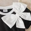 Comercio exterior transfronterizo Verano europeo y americano 26 nuevos modelos de elegantes vestidos de princesa negros con cuello redondo y lazo para bebés y niños pequeños, directo del fabricante