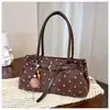 Bolso de hombro de lunares de nicho estilo coreano para mujer, nuevo bolso de axila de moda retro de alto valor para el trabajo, bolso de mano