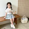 Camiseta de verano nueva de dibujos animados para niñas transfronterizas, versátil falda corta de cuadros dulces estilo pastel con volantes, conjunto de dos piezas para bebé
