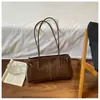 Bolsa de Axila Fashion para o Dia a Dia Feminina 2026 Novo Estilo Simples Versátil Bolsa de Ombro Único de Axila Texturizada Nicho Bolsa de Mão