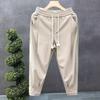 Pantalones casuales holgados de cintura elástica para hombre, moda de otoño de marca, sentido de alta gama, pantalones harem verde micro-cruz, pantalones largos de moda con cordones