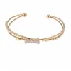 Pulseira aberta com laço duplo de zircônia, uma pulseira versátil e elegante para o dia a dia, uma peça de joalheria leve e luxuosa com um toque único e de alta qualidade, atacado