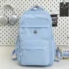 Mochila Escolar Grande Capacidade Estudante 2025 Novo Estilo Simples Tecido de Nylon Repelente à Água Mochila Casual de Viagem Mochila Feminina