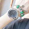 Reloj de pulsera para mujer, de oro, de marca china, de acero inoxidable, elegante reloj de pulsera con decoración de tres ojos.