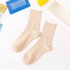 Venta directa de fábrica de calcetines de primavera con explosiones de colores sólidos japoneses de color caramelo para mujer, calcetines de colores de marea, venta al por mayor