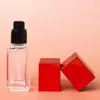 Botella cuadrada roja de 30 ml para base líquida, botella de vidrio para loción protectora, materiales de embalaje al por mayor, botella dispensadora de cosméticos