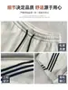 Pantalones de chándal anchos de rayas diagonales americanas azul oscuro para mujer Otoño 2026 Nuevos Simples Versátiles Sueltos Adelgazantes Pantalones Banana