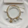 Pulseira de ilha de camada dupla com pingentes delicados de estrela-do-mar e concha, criando uma atmosfera de férias suave, acessório versátil