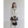 Moda de chica dulce estilo coreano: Cárdigan de punto de manga larga con cuello Peter Pan negro y corbatín, conjunto de dos piezas para mujer, otoño 2026