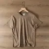 Modelo doméstico verano 2026 algodón lavado color sólido simple cuello redondo jersey camiseta de manga corta casual para hombre