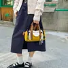 Bolsa tote redonda em bloco de cores estilo macaron coreano para atacado transfronteiriço, bolsa Boston tipo balde, bolsa transversal casual de ombro único para mulheres