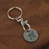 Llavero de Aleación de Zinc para Exportación Transfronteriza Europea y Americana Moneda de Token Metálico con Logo de Carrito de Compras Impulsado a Mano de Supermercado de 12 Lados