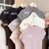 Venta al por mayor transfronteriza Verano Suéter de punto de cuello medio manga corta Camiseta interior femenina adelgazante y elegante Top interior