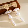 Pendientes de borla de flor de concha blanca transfronterizos europeos y americanos con perlas, pendientes de estilo de corte francés, pendientes ligeros y lujosos con un toque de alta gama