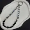 Nuevo cordón para teléfono móvil con cuentas de azúcar de cristal negro de alto valor, llavero para bolso estilo ins, cadena para teléfono móvil