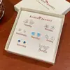 Otoño e Invierno Popular Pequeño Fresco Caja de Regalo de Pendientes de Una Semana Set para Mujer Aguja de Plata Pequeños Exquisitos Dulces Pendientes de Regalo Venta al por Mayor