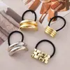 Estilo punk europeo y americano metal personalidad alta calidad cuerda para la cabeza semicírculo tubo redondo anillo para el pelo cuerda elástica para el pelo Balot fabricantes al por mayor