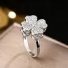 Versão coreana da venda quente rede vermelha girando quatro folhas trevo anel nicho feminino design high-end sentido aberto dedo anel joias de mão atacado