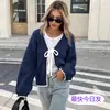 Suéter de punto con bloques de color de estilo europeo y americano para otoño e invierno, cárdigan holgado de manga larga con lazo, prenda de abrigo de estilo relajado.